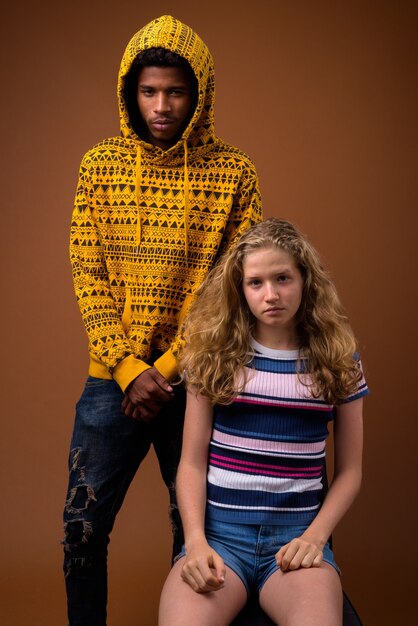 Portrait of young African man and Caucasian teenage girl