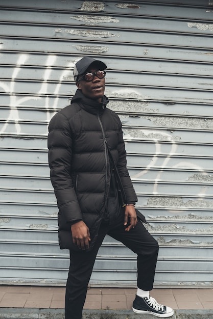 Portrait of young african man standing in the street and looking camera 