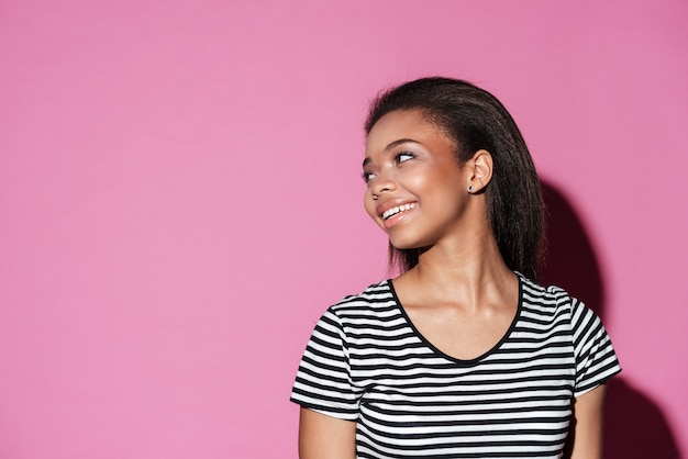 Portrait of a young african woman looking away at copyspace