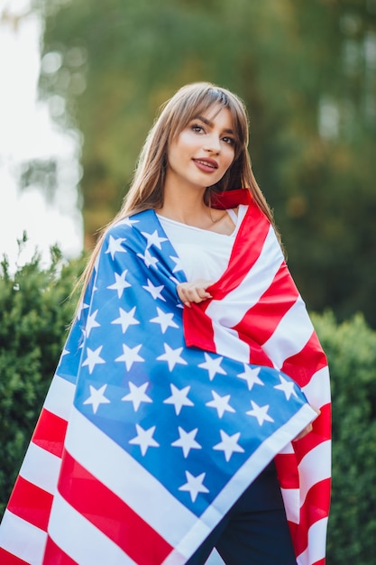 Portrait of young american girl holding USA flahg