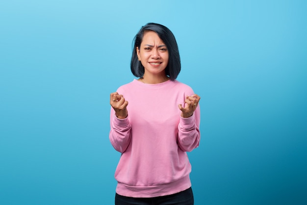 Portrait of young angry Asian woman with displeased expression