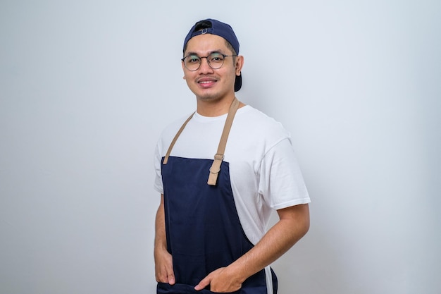 Portrait of young Asian barista smiling wearing apron