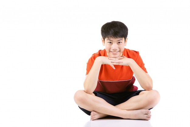 Portrait Young Asian boy sitting over white background,