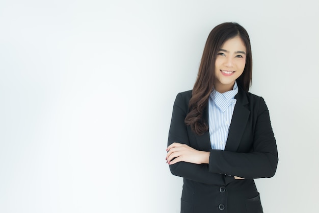 Portrait of young asian business woman crossed her arms over white background.