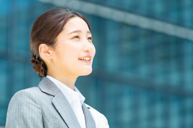 Portrait of young asian business woman in an office district