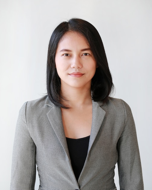 Portrait of young Asian businesswoman on white background