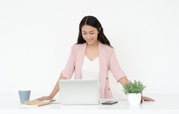 Portrait of young Asian casual woman working small business online owner standing at desk with laptop Girl freelancerentrepreneur works at homeOnline marketingeducation elearning distance work