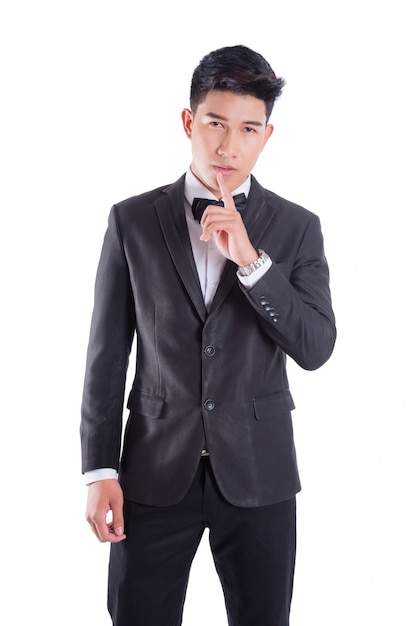 Portrait of young asian confident man dressed in tuxedo with bow tie isolated on white background