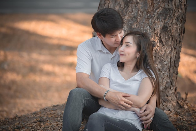 Portrait of young asian couple in love in the forestThailand people happy to be togetherValentine day concept