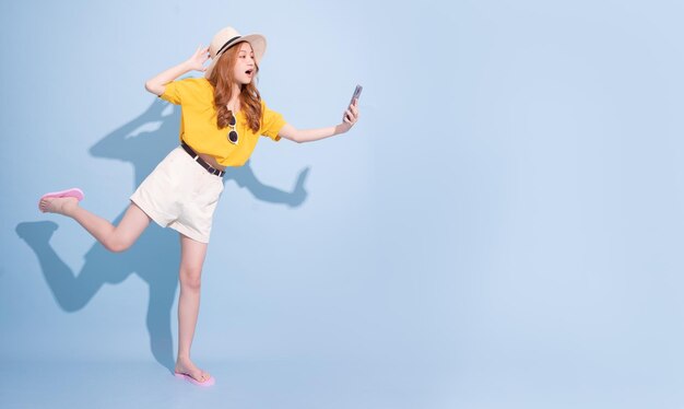 Portrait of young Asian girl on blue background summer vacation concept