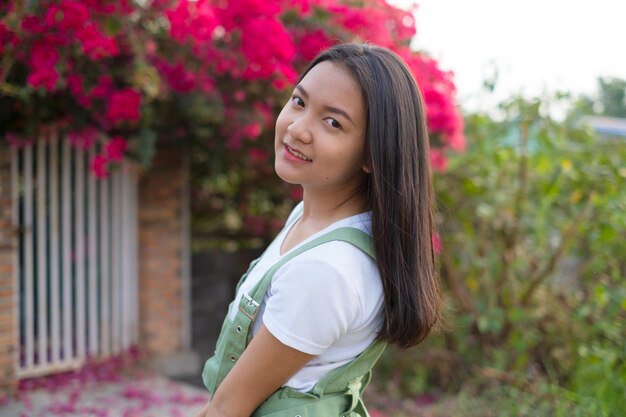 Portrait Young Asian girl outdoor beautiful flower background