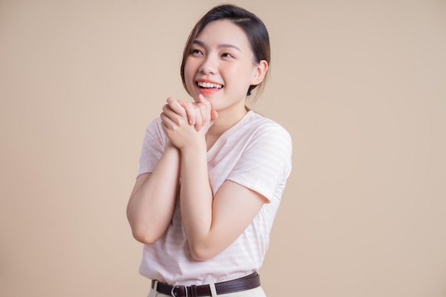 Portrait of young Asian girl posing on background