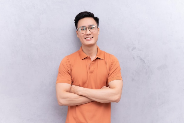 Portrait of young Asian man on background