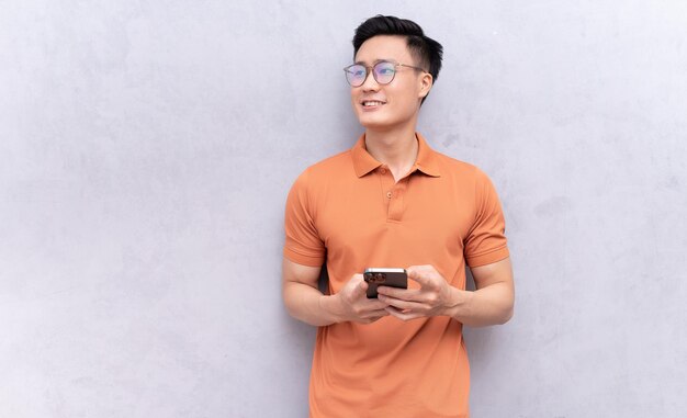 Portrait of young Asian man on background