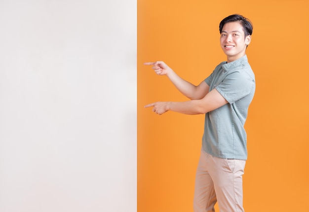 Portrait of young Asian man on background