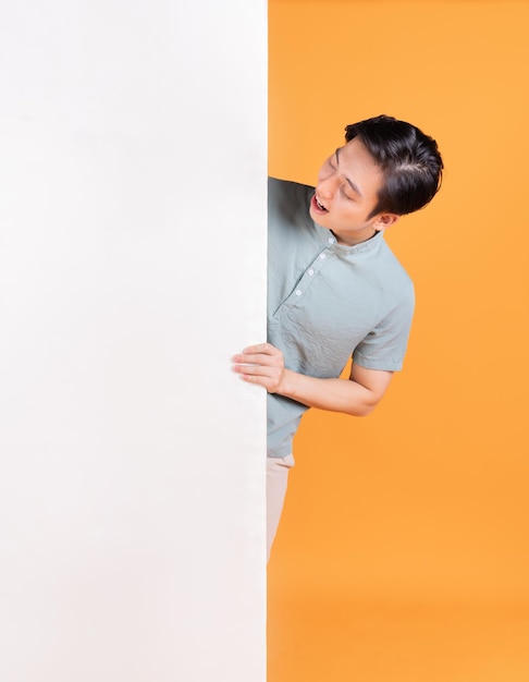 Portrait of young Asian man on background