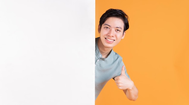 Portrait of young Asian man on background