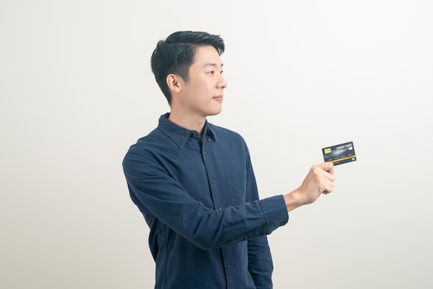 portrait young Asian man holding credit card on white background