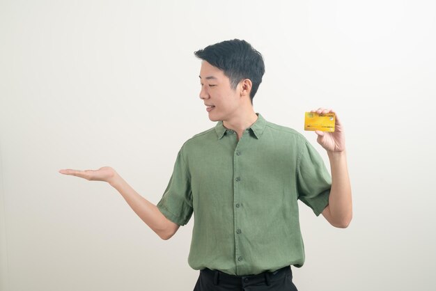 portrait young Asian man holding credit card on white background