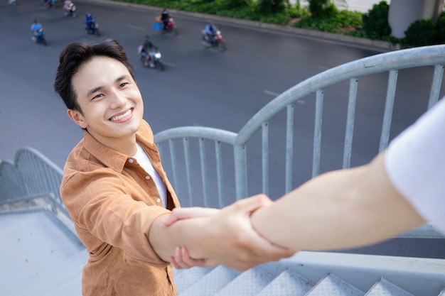 Portrait of young Asian man outside