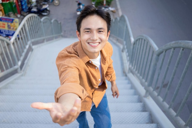 Portrait of young Asian man outside