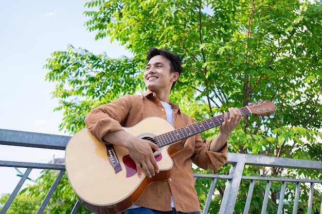 Portrait of young Asian man outside