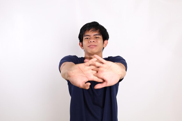 Portrait of young asian man standing while stretching isolated on white background