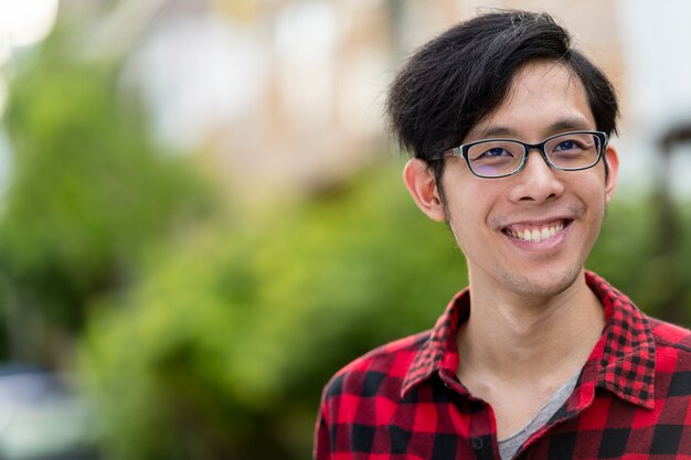 Portrait of young Asian man in the streets outdoors