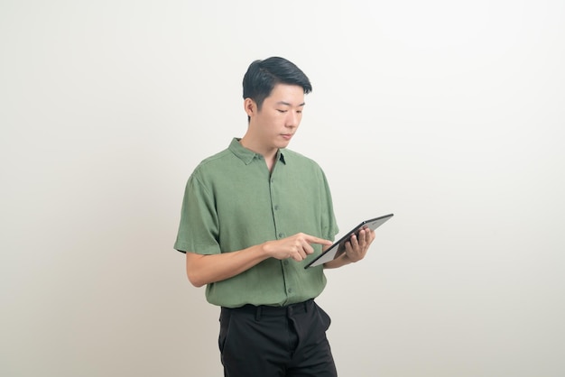 portrait young Asian man using tablet on white background