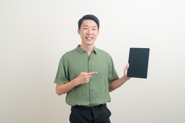 portrait young Asian man using tablet on white background