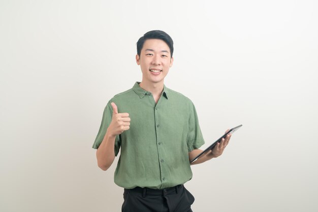 portrait young Asian man using tablet on white background