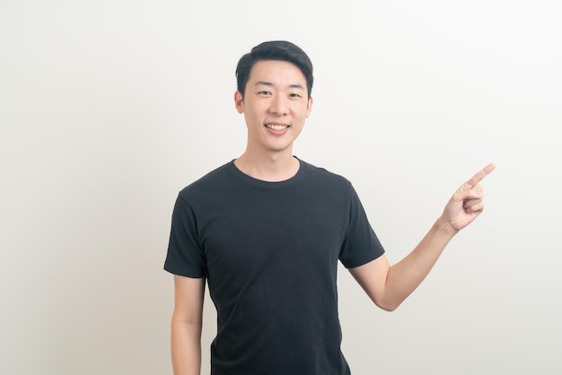 portrait young Asian man with hand pointing or presenting on white background