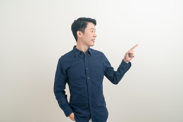 portrait young Asian man with hand pointing or presenting on white background