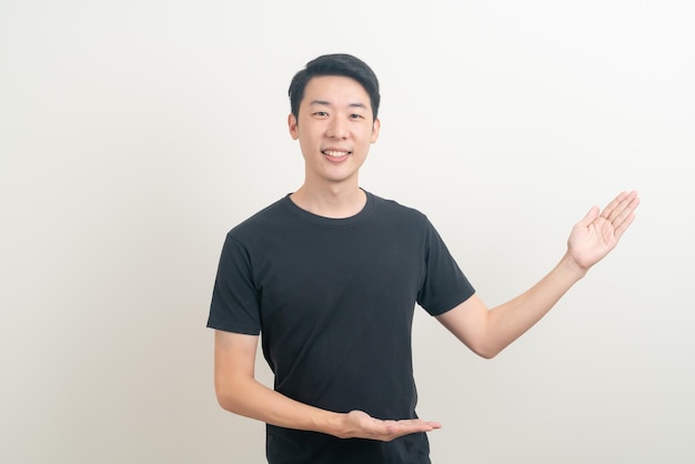 portrait young Asian man with hand pointing or presenting on white background