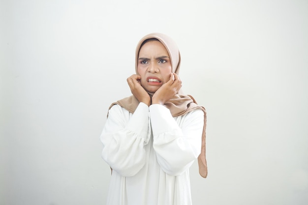 Portrait of young Asian muslim woman panic and fear on white background