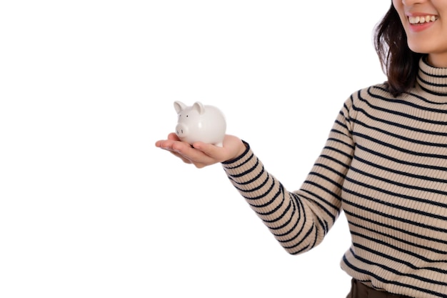 Portrait of young Asian woman casual uniform holding white piggy bank isolated on white background Financial and bank saving money concept