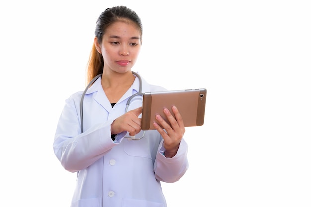 Portrait of young Asian woman doctor using digital tablet