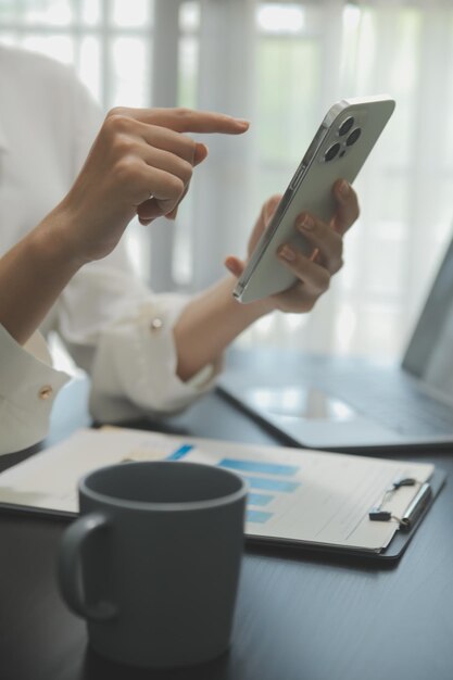 Portrait of Young Asian woman hand freelancer is working her job on computer tablet in modern office Doing accounting analysis report real estate investment data Financial and tax systems concept