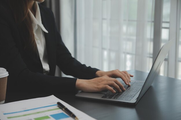 Portrait of Young Asian woman hand freelancer is working her job on computer tablet in modern office Doing accounting analysis report real estate investment data Financial and tax systems concept