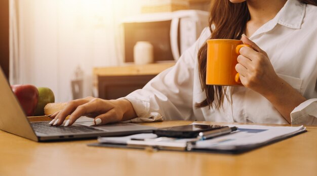 Portrait of Young Asian woman hand freelancer is working her job on computer tablet in modern office Doing accounting analysis report real estate investment data Financial and tax systems concept