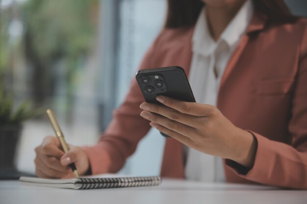 Portrait of Young Asian woman hand freelancer is working her job on computer tablet in modern office Doing accounting analysis report real estate investment data Financial and tax systems concept