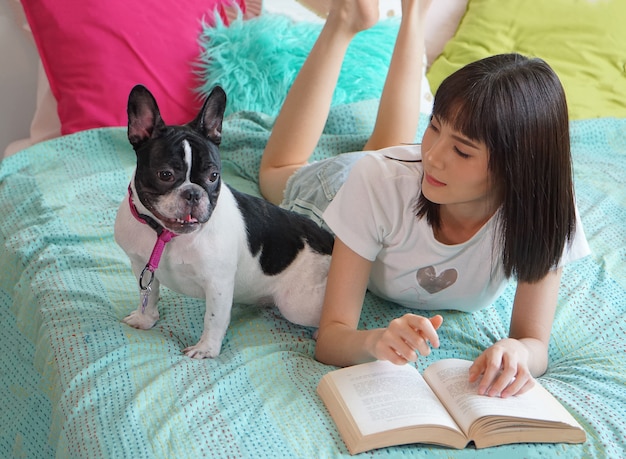 Portrait Of Young Asian Woman play with dog