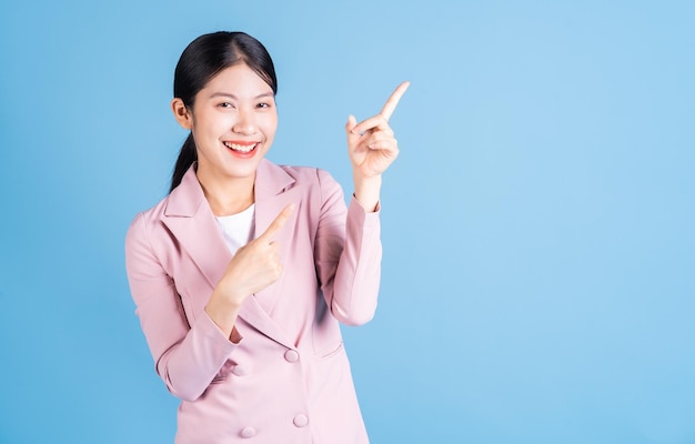 Portrait of young Asian woman posing on background