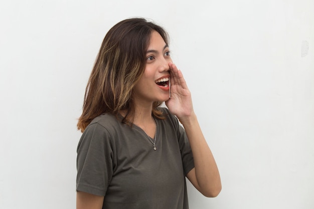 Portrait of young Asian woman shouting and yelling