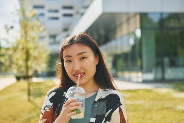 Portrait of young asian woman that is outdoors at daytime