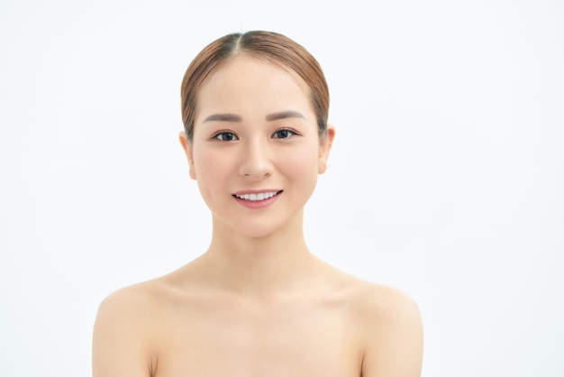 Portrait of young Asian woman with natural skin on white background