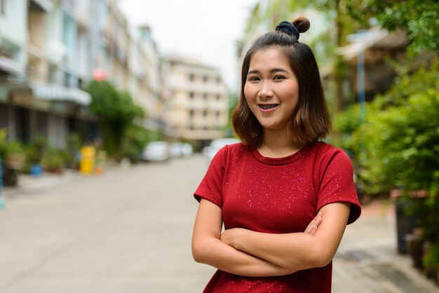 Portrait of young Asian woman with short hair in the streets outdoors