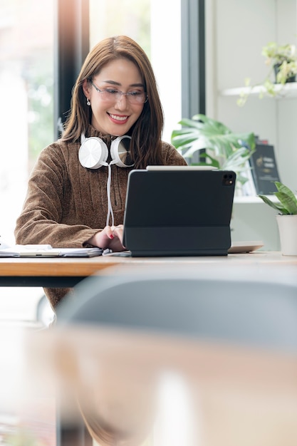 Portrait of young asian woman working at home office with happiness, successful concept.