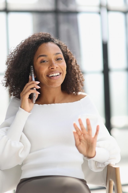 Portrait of a young attractive African American woman using a smartphone