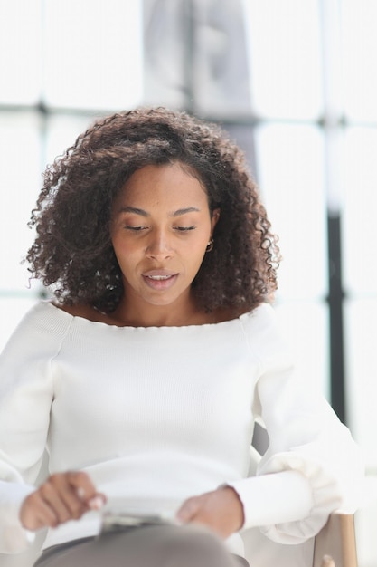 Portrait of a young attractive african american woman using a smartphone